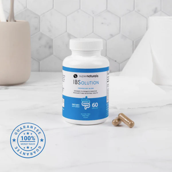 A bottle of IBSolution with two amber capsules